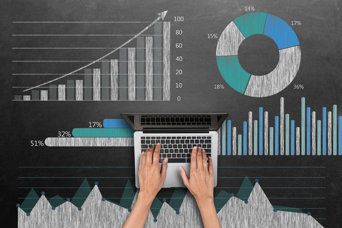 hands-on-laptop-with-data-analytics-charts-and-graphs-on-blackboard